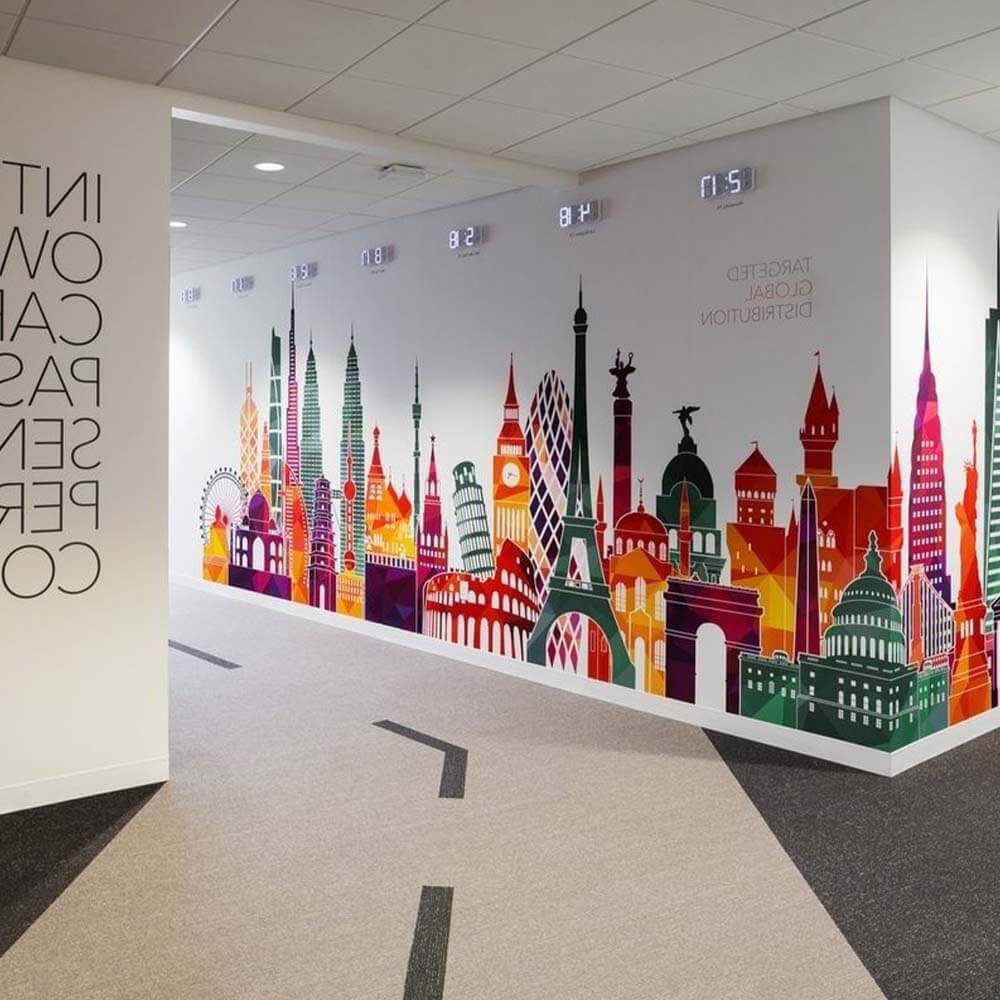 Colourful world landmarks mural printed across an office wall