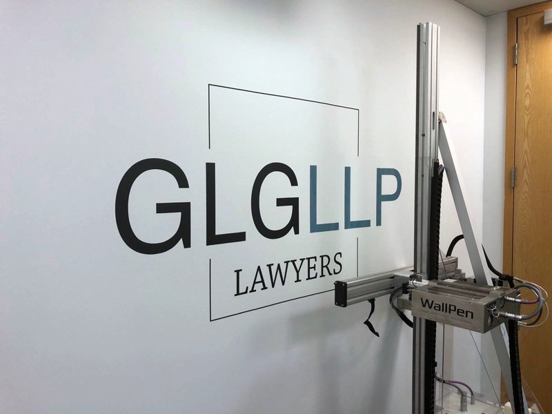 Company logo and signage printed directly onto an office wall